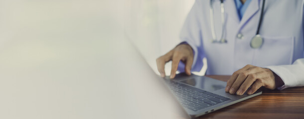 Doctor using computer in office.