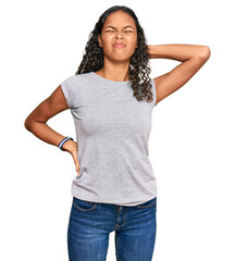 Obraz premium Young african american girl wearing casual clothes suffering of neck ache injury, touching neck with hand, muscular pain