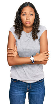 Young african american girl wearing casual clothes shaking and freezing for winter cold with sad and shock expression on face