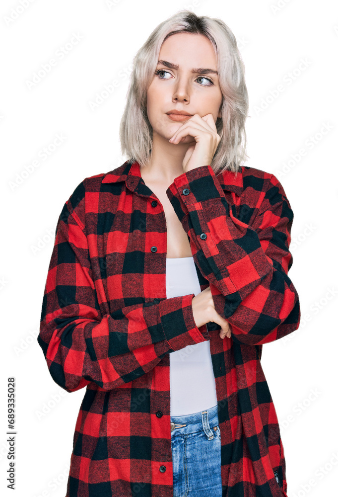 Wall mural young blonde girl wearing casual clothes serious face thinking about question with hand on chin, tho