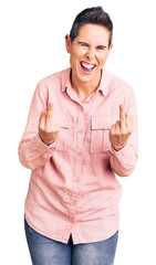 Young woman with short hair wearing casual clothes showing middle finger doing fuck you bad...