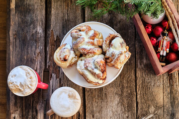 cinnamon rolls. Brioche. Top view, wooden background, icing sugar, cocoa, yeast buns.