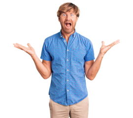 Handsome caucasian man with beard wearing casual clothes celebrating victory with happy smile and winner expression with raised hands