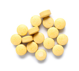 Many yellow pills on white background