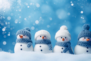 Snowman family in knitted hat and scarf on snow background.