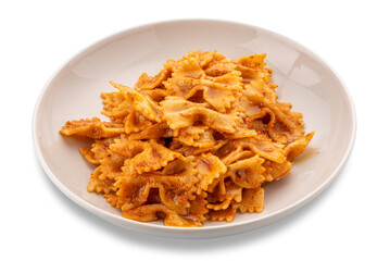 Farfalle pasta with tomato and chili and garlic sauce and olive oil in white plate isolated