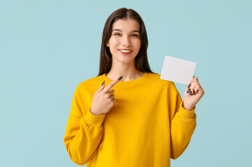 Woman with voting paper on light blue background