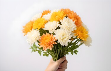 woman hand is holding a festive bouquet with chrysathemum flowers on white background