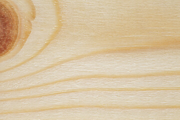 Surface of wooden board in close-up with trace of part of wooden knot