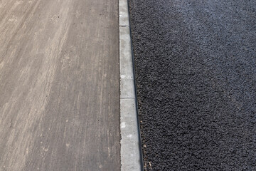 Fototapeta premium asphalting a new highway with black new asphalt