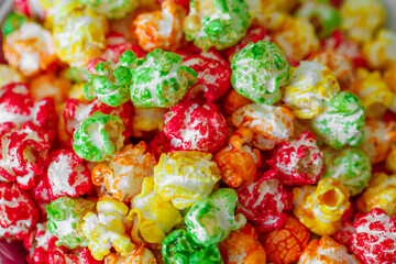 Popcorn in multicolored sweet glaze, in bulk, close-up, selective focus
