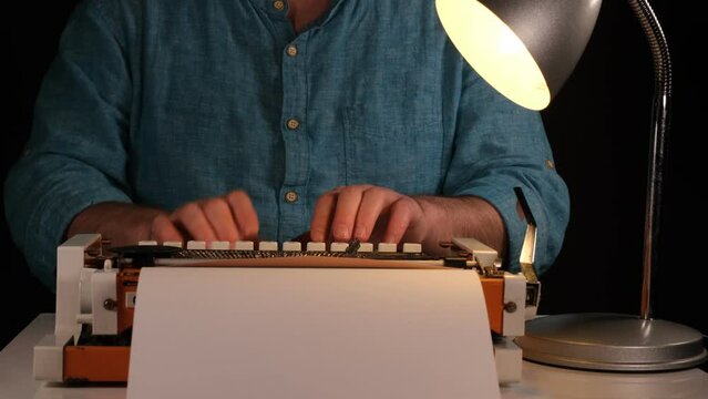 man writing with typewriter 