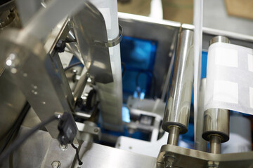 Closeup of coffee packaging machine at production factory, copy space