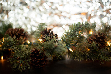 Close-up of a New Year's garland on a black background and a background of crumpled silver foil. Place for text. Postcard. Merry Christmas and Happy New Year