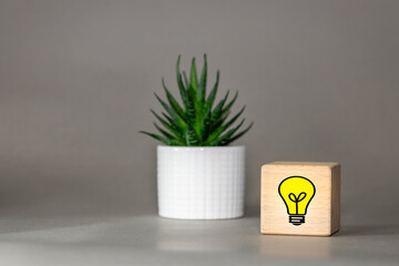 Creative idea concept, Light bulb Symbol of a new idea on a wooden block, next to it is a sequin...