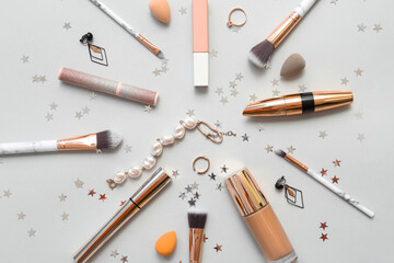 Christmas composition with makeup cosmetics, jewelry and decor on white background