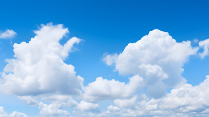 Naklejka na ściany i meble Soft fluffy clouds on a bright blue sky.