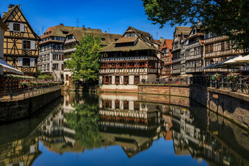Ornate traditional half timbered houses with blooming flowers along the canals in the picturesque Petite France district of Strasbourg, Alsace, France