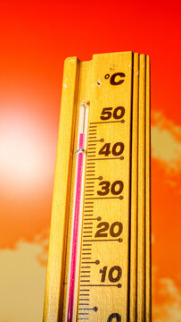 The thermometer displays a high heatwave temperature of 47 degrees Celsius. A red alarm gives a warning of the extreme weather conditions caused by global climate change on Earth. Hot summer season.