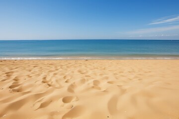 Idyllic golden sandy beach with crystal clear turquoise water glistening under the warm summer sun