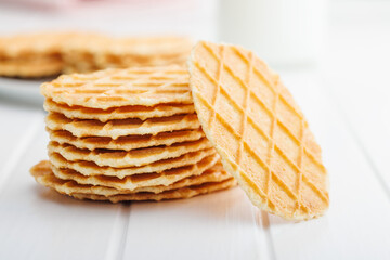 Round waffle biscuits on white table.