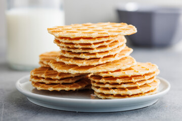 Round waffle biscuits on plate on kitchen table.