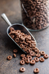Sweet breakfast cereals in scoop on kitchen table.