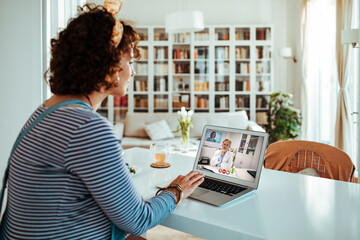 Woman at home talking to doctor on video call