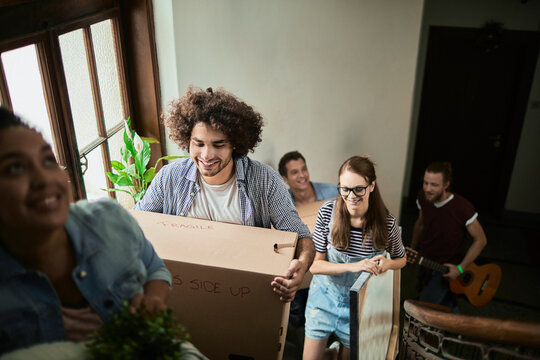 Group of young people moving into their new apartment