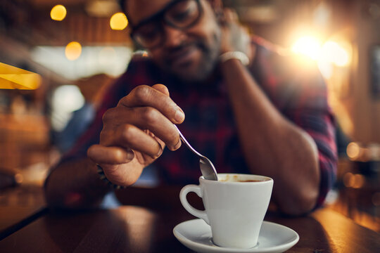 Man Enjoying a Fresh Cup of Coffee in Cafe
