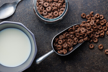 Sweet breakfast cereals in scoop on kitchen table. Top view.