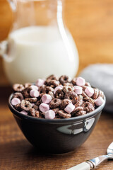Sweet breakfast cereals in bowl on kitchen table.