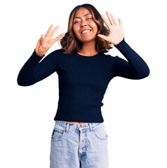 Obraz na płótnie Canvas Young beautiful mixed race woman wearing casual clothes showing and pointing up with fingers number eight while smiling confident and happy.