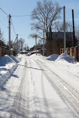 Winter clean road in the village at cold sunny day