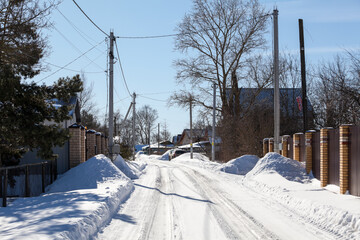 Roads cleared of snow in a village in winter