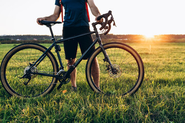 Mountain biker cycling a bike during ar sunset outside. Healthy lifestyle and outdoor adventure concept