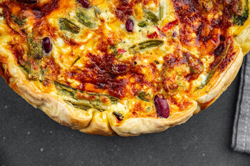 open pie quiche vegetable savory baked corn, green peas, beans, green beans, bell pepper healthy eating cooking appetizer meal food snack on the table copy space food background