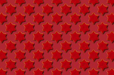 Pattern of christmas gingerbread star on red pastel background