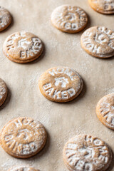Homemade gingerbread cookies on parchment background pattern. Christmas traditional desserts concept