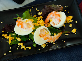 Image of a dish of Mimosa eggs with shrimps and herbs