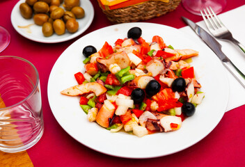 Traditional Spanish Salpicon de Marisco, cold salad from various seafood with vegetables and olives