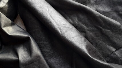 Dark genuine leather for sewing and needlework. Texture of genuine leather. Haberdashery, clothing leather. - obrazy, fototapety, plakaty