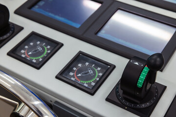 Azimuth thrusters control lever and angle indicators mounted in a tug boat control panel - obrazy, fototapety, plakaty