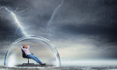 Businesswoman is relaxing during a storm as concept of insurance and protection - obrazy, fototapety, plakaty