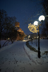Ancient ukrainian Pyatnytska and Christmas bells illumination on a lamp