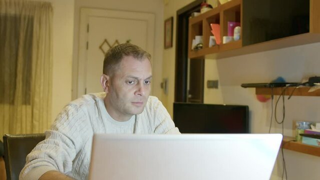The father works from home on a laptop, and the child boy comes and hugs him. Daddy and son bonding. High quality 4k footage