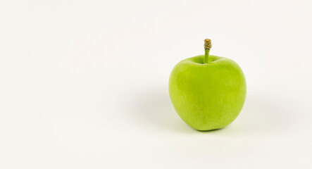 Green apple on a white background with space for text.