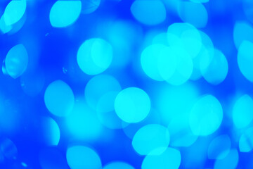Blurry blue Christmas lights. Lights out of focus. Christmas and New Year abstract background. Template for custom design. Festive wallpaper.
