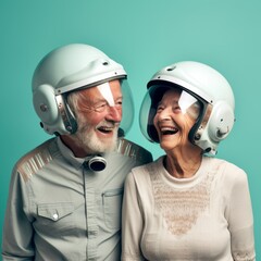 Smiling old man and old woman with astronaut helmet against mint wall 