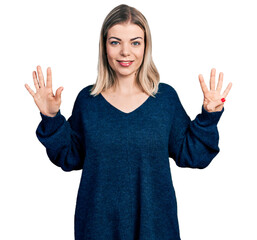 Young blonde woman wearing casual sweater showing and pointing up with fingers number nine while...